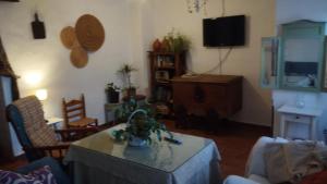 a living room with a table and a tv at El rinconcito in Fuenteheridos