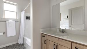 a white bathroom with a sink and a mirror at Landing Apartments - Woodburn in Woodburn +57 photos