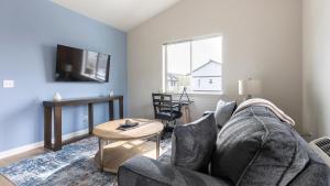 a living room with a couch and a table at Landing Apartments - Woodburn in Woodburn