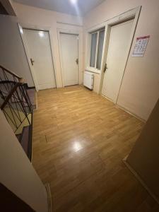 an empty room with doors and a wooden floor at Taksim Şato Hotel in Istanbul
