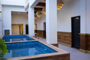 a jacuzzi tub in the middle of a building at Hotel Boutique Lumiere in Tampico +5 photos