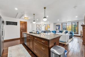 a kitchen and living room with a couch and a table at Vail Valley Retreat Shared Pool Hot Tub & Sauna in Avon +38 photos