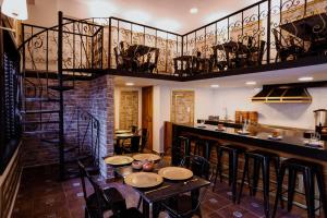 a restaurant with a bar with tables and a balcony at Hotel Boutique Lumiere in Tampico