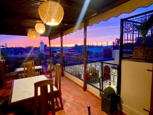 a balcony with a table and a view of the city at Riad Prada in Marrakech