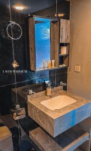 a bathroom with a sink and a window at Laver wadi rum in Wadi Rum