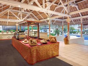 a resort lobby with a table with pillows on it at Mercure Resort Sanur in Sanur