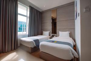 Postel nebo postele na pokoji v ubytování The Quadrant Hotel KNO