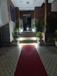 a hallway with a red carpet in a building at blue door imsouane in Imsouane