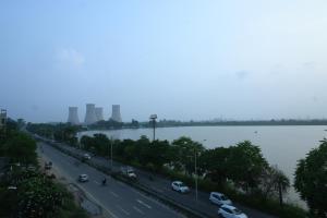 a highway with cars on it next to a body of water at Hotel Lake Casa in Bathinda