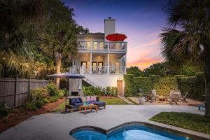 a house with a swimming pool in front of a house at 225 Olive Way in East End