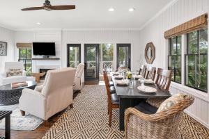 a living room with a dining room table and chairs at 225 Olive Way in East End