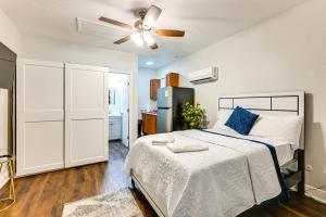 a bedroom with a bed and a ceiling fan at 7 Mi to Busch Gardens Lutz Home with Patio! in Lutz
