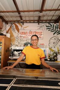a man in a yellow shirt standing behind a counter at Kim in Cartagena de Indias +53 photos