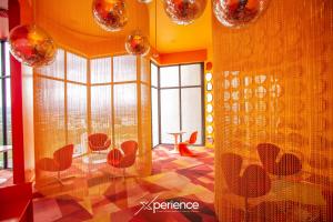a room with chairs and a table and windows at Indigo at 11, City Views and Wonderland Vibes! in Hatillo