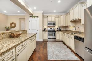 a kitchen with white cabinets and granite counter tops at 903 Reserve Lane in Jewtown