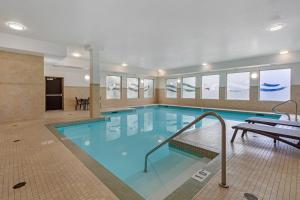 a large pool with blue water in a building at Best Western Plus St Albert in St. Albert