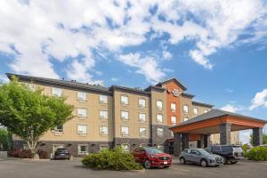 a building with cars parked in a parking lot at Best Western Plus St Albert in St. Albert