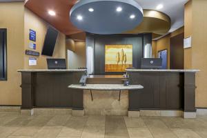 a lobby with two counters with laptops on them at Best Western Plus St Albert in St. Albert +33 photos