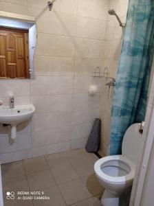 a bathroom with a toilet and a sink at Vienības 28 in Daugavpils