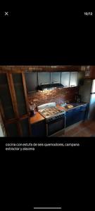 a kitchen with a stove and a counter top at El Manik cabañas El Tlayan in Tala