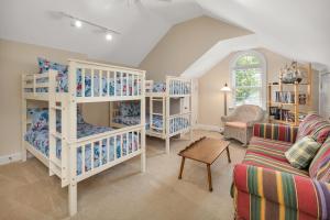 a living room with white bunk beds and a couch at 4324 Tenth Street in Saint Simons Island +19 photos