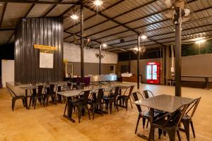 a group of tables and chairs in a large room at Dandeli Tiger Cottages in Dandeli +19 photos