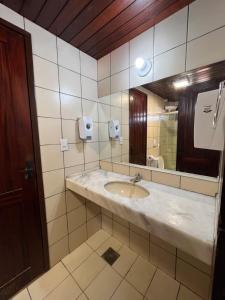 a bathroom with a sink and a mirror at Kaza Cumbuco Hostel in Caucaia +42 photos