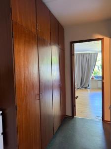 a hallway with wooden cabinets and a door to a room at Studio apartment in Central Copenhagen in Copenhagen
