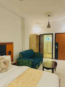 a hotel room with a bed and a couch and a table at Residence samba in Douala