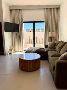 a living room with a couch and a coffee table at Modern beach house in San Carlos in San Carlos