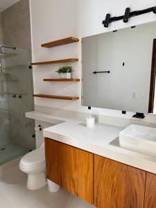 a bathroom with a sink and a toilet and a mirror at Modern beach house in San Carlos in San Carlos +11 photos