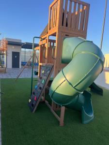 a playground with a slide on the grass at Modern beach house in San Carlos in San Carlos