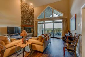 a living room with a couch and a fireplace at Sugar Sky at The Reserve II in Sugar Mountain