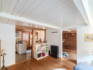 a living room with white walls and wood floors at Mys Chalet - Authentique & rénové in Jaun