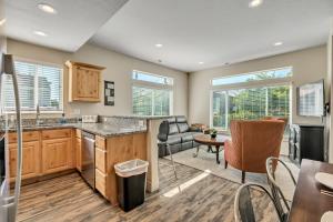 a kitchen and living room with a table and chairs at Hill Field Stays by Cloud Dream Homes in Layton