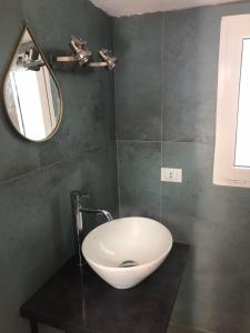 a bathroom with a sink and a mirror at Casa Pejda in Bonassola