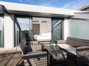a patio with chairs and a table on a roof at Novotel Cardiff Centre in Cardiff
