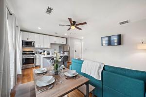 a living room with a table and a blue couch at Homey Apt Nr Med Center Fire Pit Bbq Wifi Games in Houston