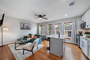 a kitchen and living room with a couch and a table at Homey Apt Nr Med Center Fire Pit Bbq Wifi Games in Houston