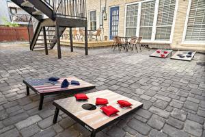 a patio with a table with hats and a piano at Homey Apt Nr Med Center Fire Pit Bbq Wifi Games in Houston
