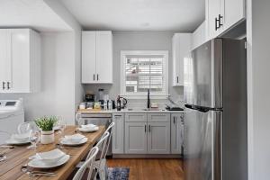 a kitchen with white cabinets and a stainless steel refrigerator at Nr Med Center, Museum Wifi Games Bbq Fire Pit in Houston +19 photos