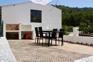 a black table and chairs on a patio at Estudio Finca Mas el Bravo in Caudiel