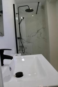 a bathroom with a white sink and a shower at Estudio Finca Mas el Bravo in Caudiel