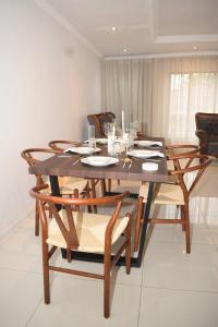 a dining room with a wooden table and chairs at The Hide Nongoma in Nongoma