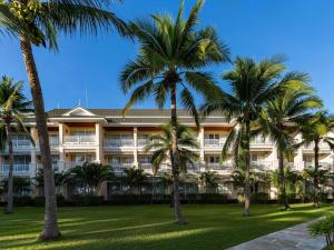 a hotel with palm trees in front of it at Sofitel Krabi Phokeethra Golf and Spa Resort in Klong Muang Beach