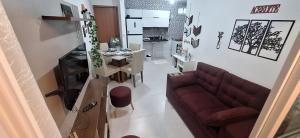 a living room with a couch and a table at Precioso Lar 2 in Gramame