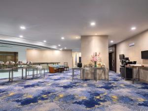 a large room with tables and chairs in a building at Novotel Kuala Lumpur City Centre in Kuala Lumpur