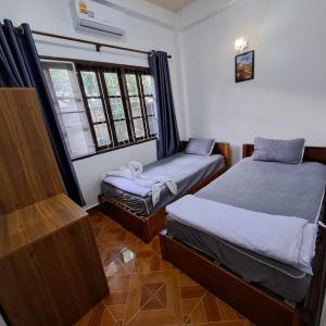 Postel nebo postele na pokoji v ubytování Sichaluenkham vangvieng HOTEL + 11 fotografií