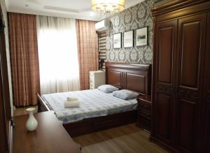 a small bedroom with a bed and a table at 15-69 Oasis-3 kom in Aktau