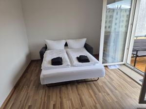 a bedroom with a bed and a large window at Domspitze in Schwerin